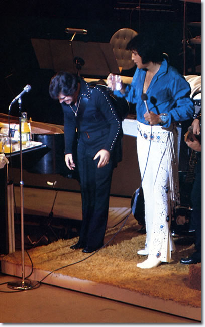 Charlie Hodge and Elvis Presley on stage