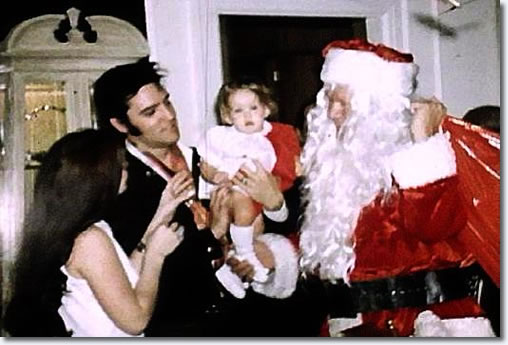 Elvis Presley with Priscilla, Lisa Marie and Vernon (Santa) Presley