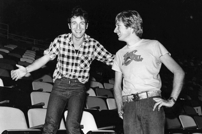 The Two Bruces — 'B.J.' and 'The Boss' — sharing a laugh and a quick break from one of their legendary soundcheck walks at Madison Square Garden in August 1978. Photograph courtesy of Bruce Jackson.